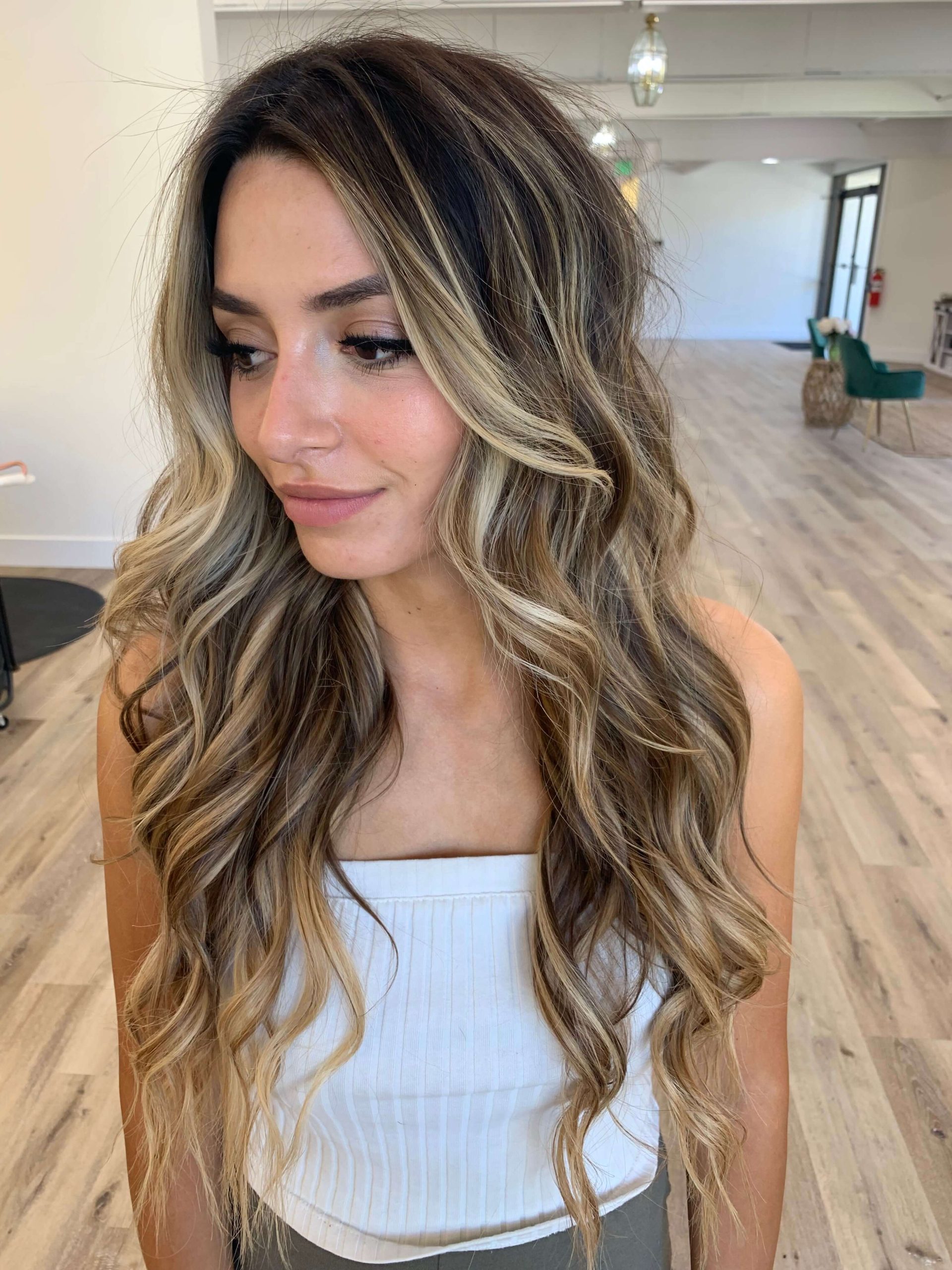 woman in salon with blonde and brown hair extensions