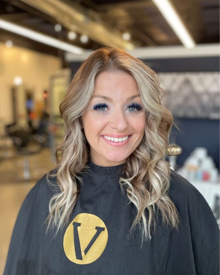 blonde woman with custom hand-sewn hair extensions in studio v salon